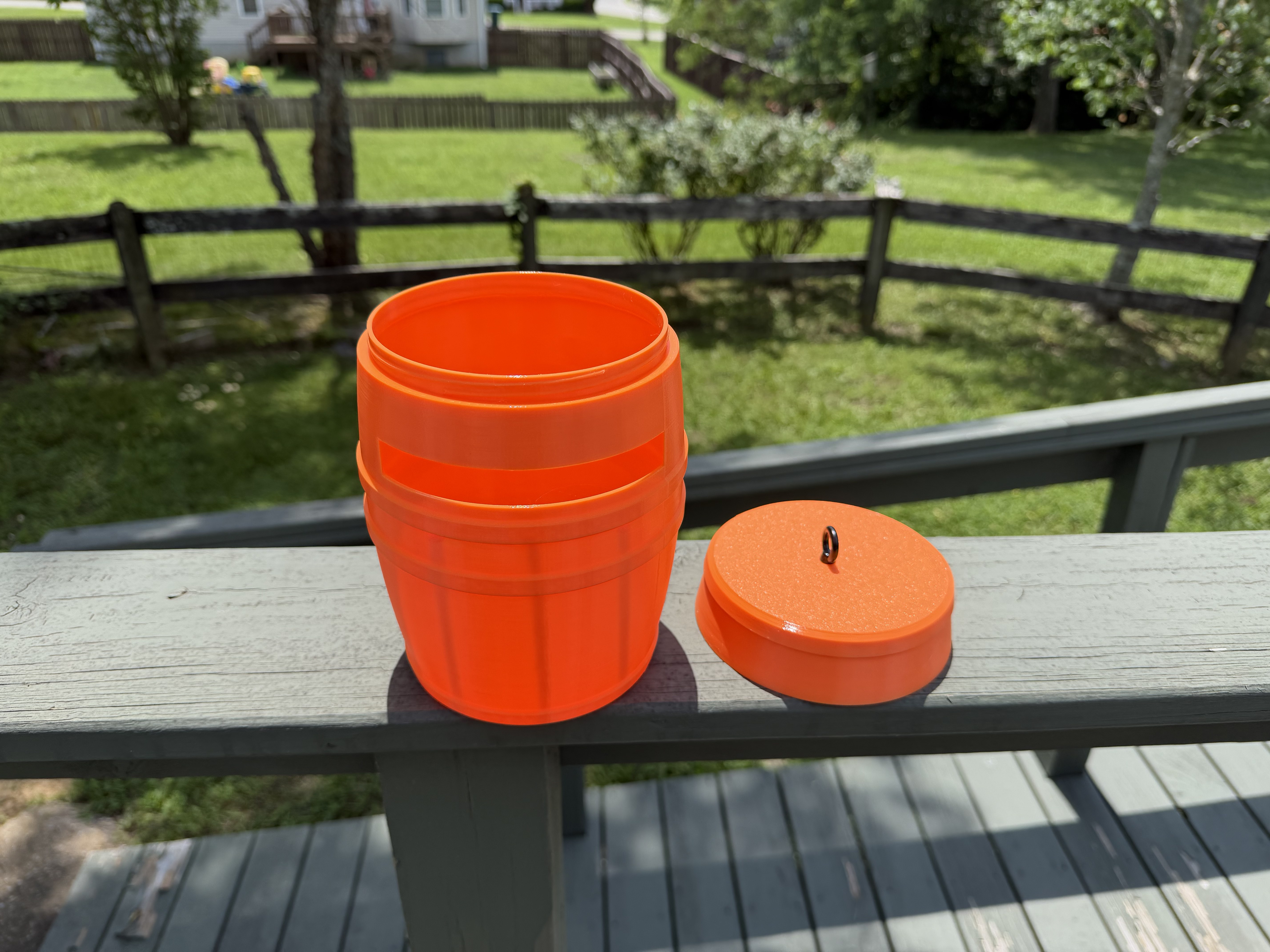 Orange barrel with hand for scale